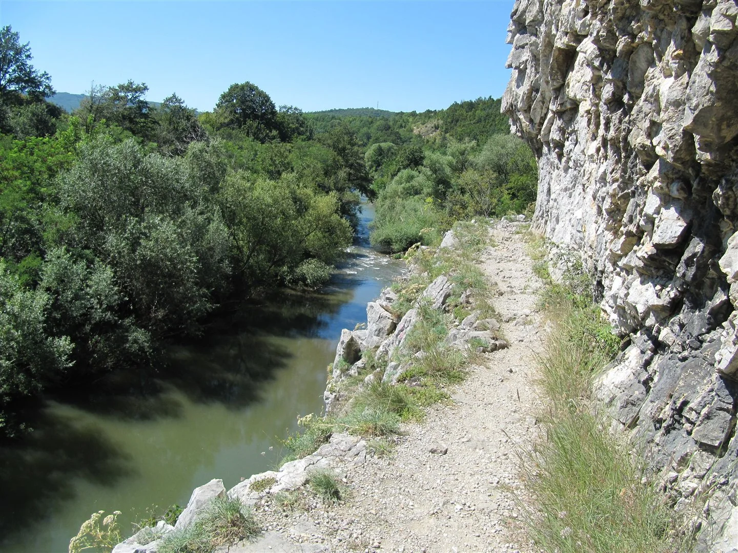 Nera River beside a limestone cliff and forested gorge